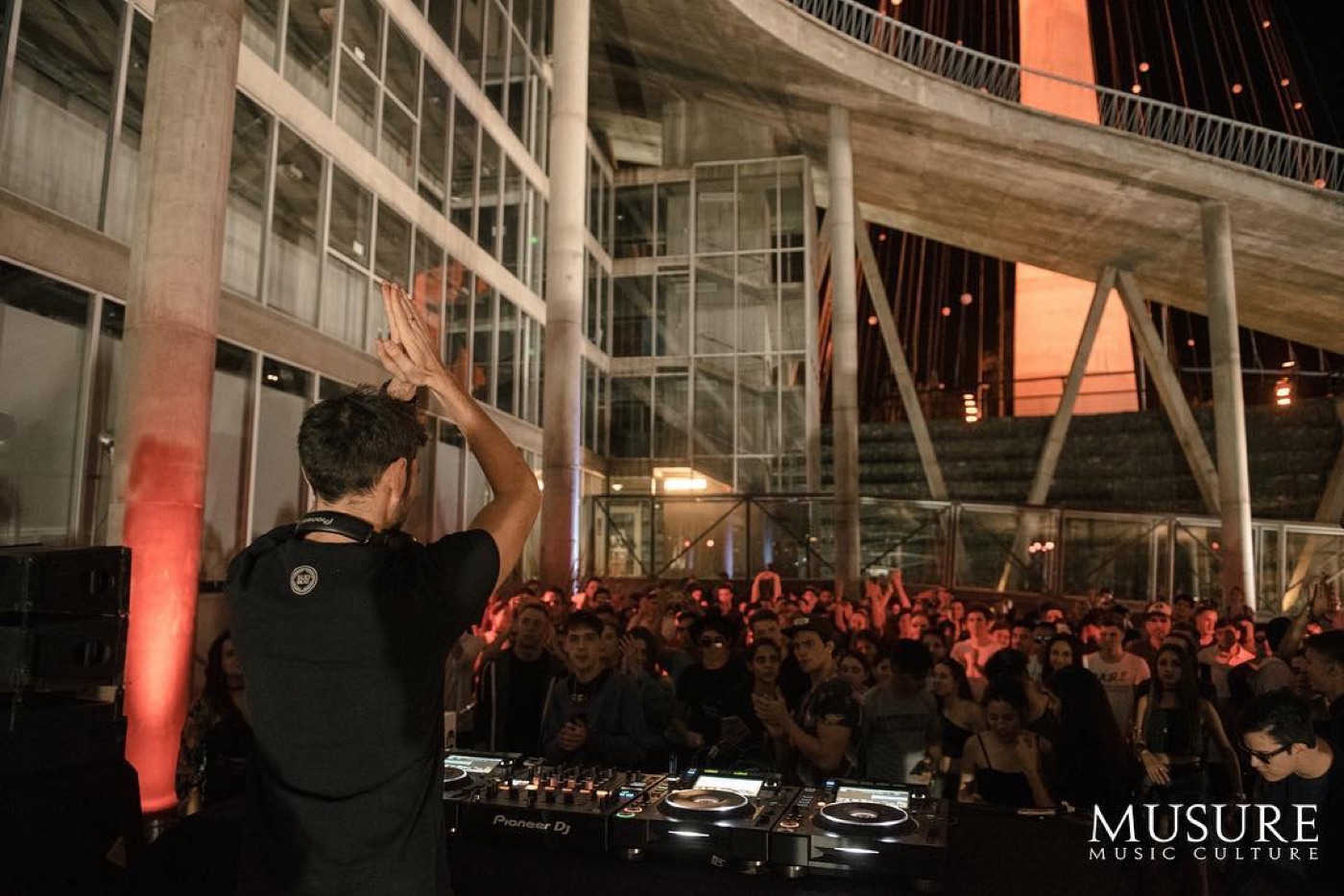 Open air show in front of a lit building